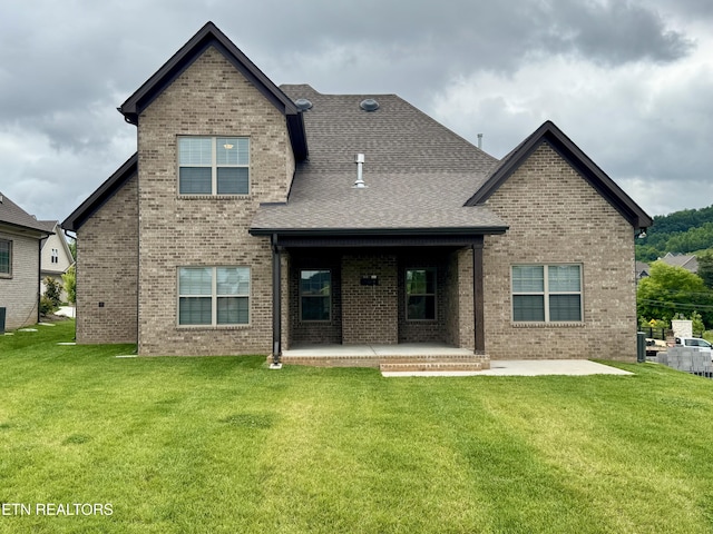 2107 Lantern Park Ln, Knoxville, TN 37932 - rear view of house featuring a patio area, brick siding, a yard, and roof with shingles
