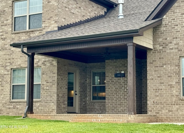 2107 Lantern Park Ln, Knoxville, TN 37932 - property entrance featuring roof with shingles, ceiling fan, and brick siding