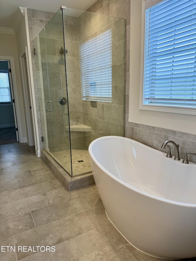 2107 Lantern Park Ln, Knoxville, TN 37932 - bathroom with a soaking tub, a shower stall, and ornamental molding