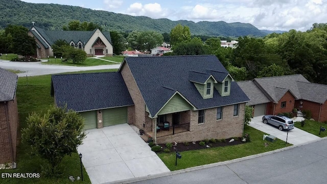 135 Whisper Creek Rd, Lafollette, TN 37766 - view of front of property with driveway, brick siding, a front yard, a garage, and a mountain view
