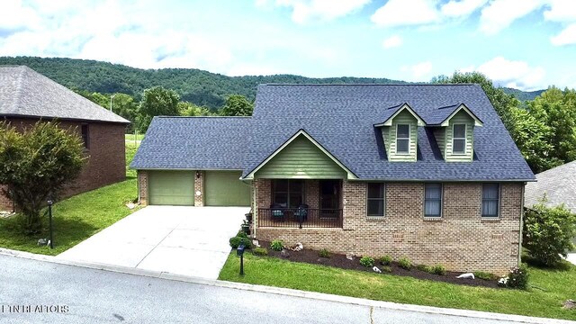 135 Whisper Creek Rd, Lafollette, TN 37766 - cape cod home with brick siding, concrete driveway, a garage, a front yard, and roof with shingles