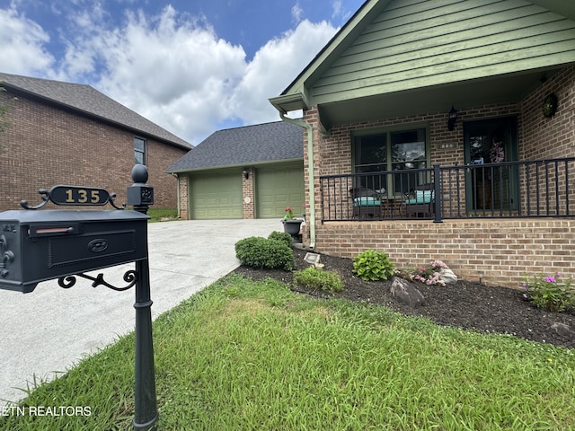 135 Whisper Creek Rd, Lafollette, TN 37766 - view of side of home featuring brick siding, concrete driveway, covered porch, and an attached garage