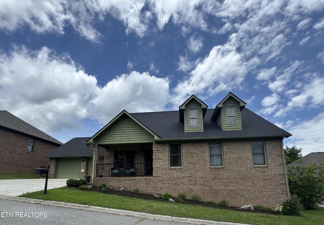 135 Whisper Creek Rd, Lafollette, TN 37766 - view of front of home featuring brick siding, driveway, a garage, and a front yard