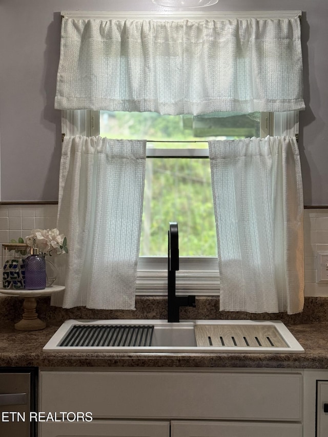 135 Whisper Creek Rd, Lafollette, TN 37766 - kitchen view of white cabinetry, dark countertops, and decorative backsplash
