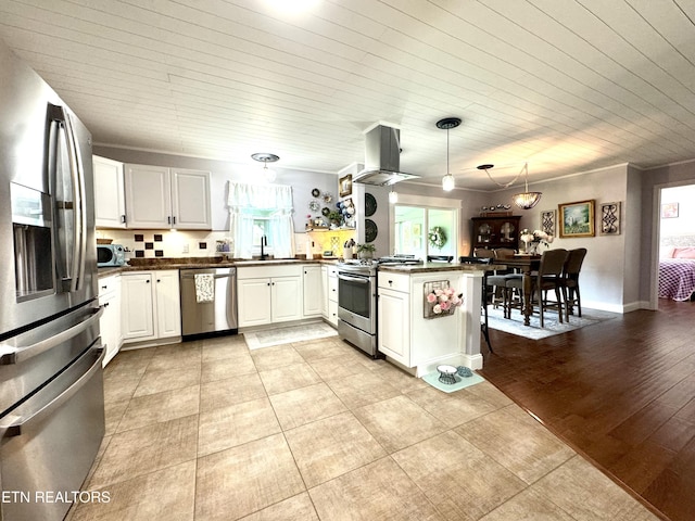 135 Whisper Creek Rd, Lafollette, TN 37766 - kitchen featuring appliances with stainless steel finishes, island range hood, dark countertops, a peninsula, and wood ceiling