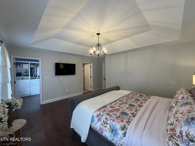 135 Whisper Creek Rd, Lafollette, TN 37766 - bedroom featuring a raised ceiling, a chandelier, wood finished floors, and a spacious closet