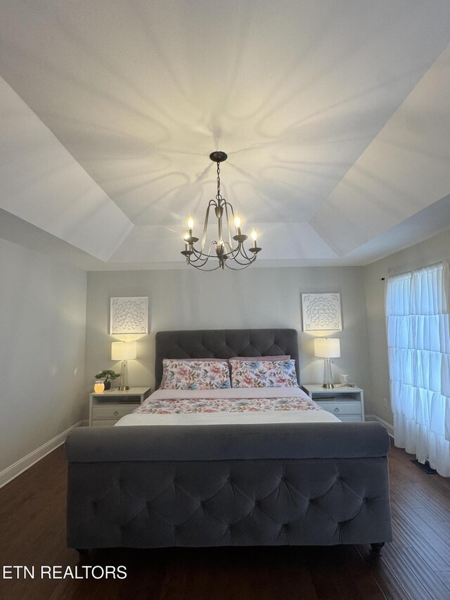 135 Whisper Creek Rd, Lafollette, TN 37766 - bedroom featuring a chandelier, dark wood-style floors, and a tray ceiling