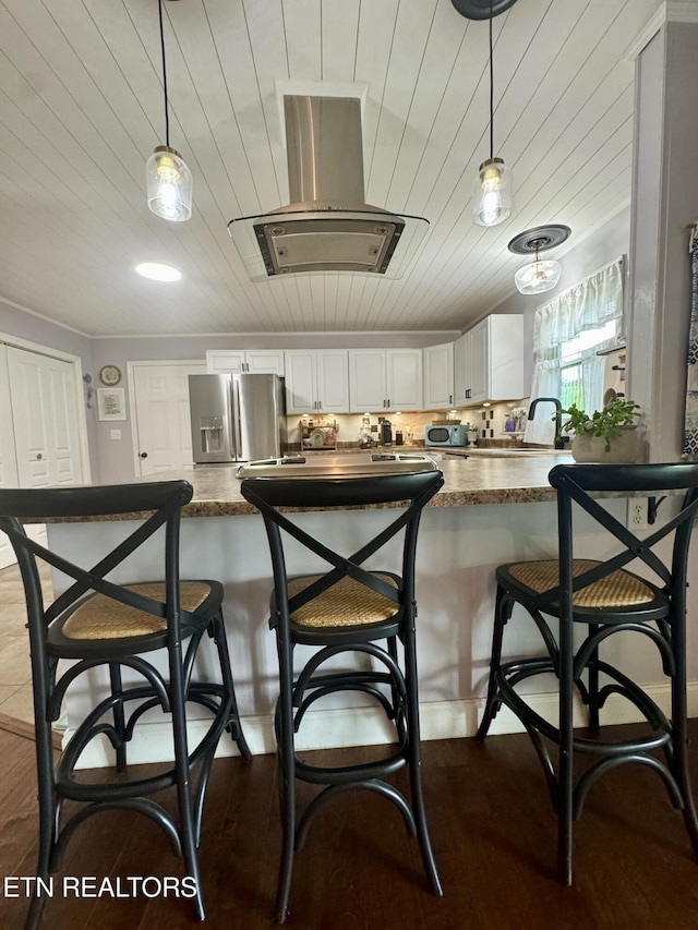 135 Whisper Creek Rd, Lafollette, TN 37766 - kitchen featuring stainless steel fridge, pendant lighting, white cabinets, a kitchen breakfast bar, and wooden ceiling
