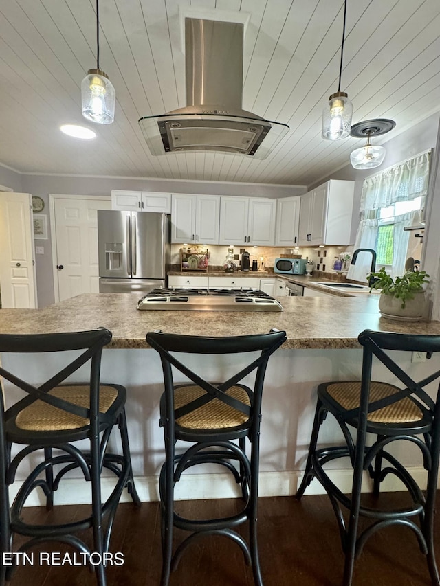 135 Whisper Creek Rd, Lafollette, TN 37766 - kitchen featuring appliances with stainless steel finishes, ventilation hood, pendant lighting, a peninsula, and wood ceiling