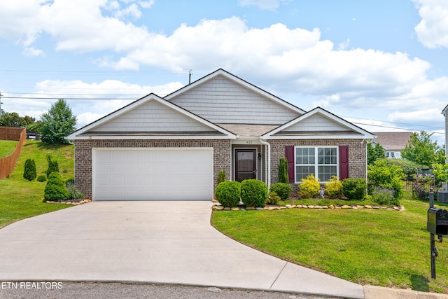 1426 Mesquite Dr, Sevierville, TN 37876 - view of front of property featuring a garage, driveway, and brick siding