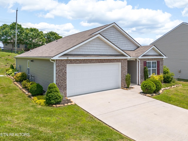 1426 Mesquite Dr, Sevierville, TN 37876 - view of front of property with an attached garage, concrete driveway, brick siding, a front lawn, and a shingled roof