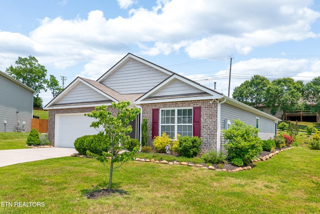 1426 Mesquite Dr, Sevierville, TN 37876 - view of front facade featuring brick siding, an attached garage, driveway, and a front yard