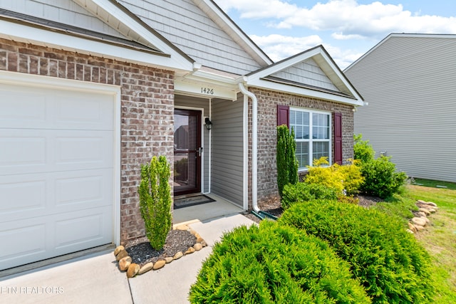 1426 Mesquite Dr, Sevierville, TN 37876 - doorway to property with brick siding and an attached garage