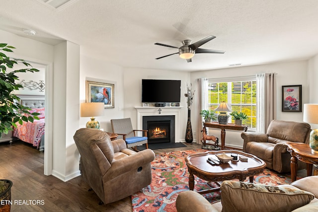 1426 Mesquite Dr, Sevierville, TN 37876 - living area with a fireplace with flush hearth, ceiling fan, dark wood finished floors, and a textured ceiling