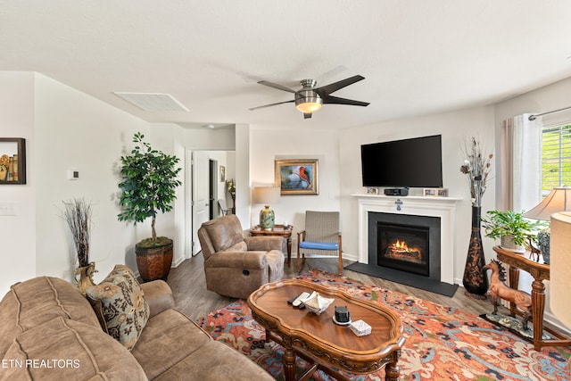 1426 Mesquite Dr, Sevierville, TN 37876 - living area with wood finished floors, ceiling fan, and a fireplace with flush hearth