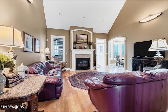 510 Argyle Way, Maryville, TN 37801 - living room with high vaulted ceiling, a fireplace with flush hearth, light wood-type flooring, and arched walkways
