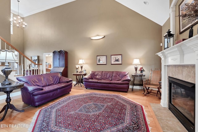 510 Argyle Way, Maryville, TN 37801 - living room featuring high vaulted ceiling, wood finished floors, a tile fireplace, stairs, and ornamental molding