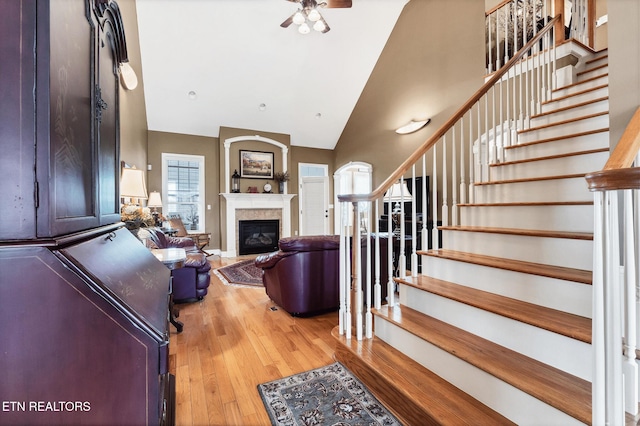 510 Argyle Way, Maryville, TN 37801 - living room featuring high vaulted ceiling, wood finished floors, stairway, a ceiling fan, and a glass covered fireplace