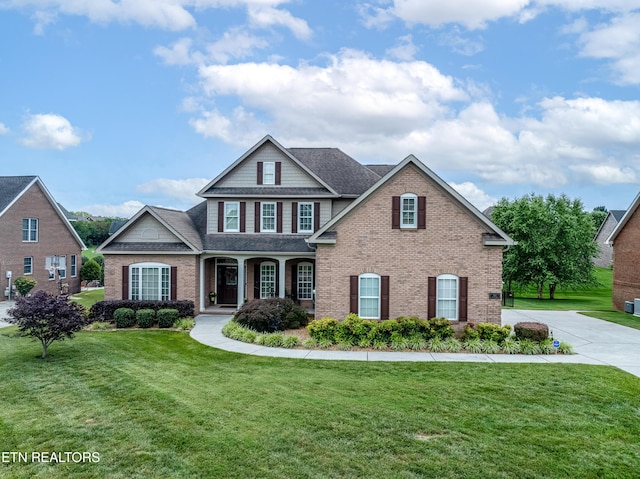 510 Argyle Way, Maryville, TN 37801 - traditional-style home featuring brick siding, a front yard, a shingled roof, and a porch