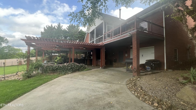 1843 River Vista Cir, Sevierville, TN 37876 - back of house featuring concrete driveway, a garage, a pergola, and a sunroom