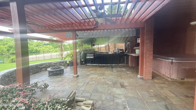 1843 River Vista Cir, Sevierville, TN 37876 - view of patio / terrace featuring a fire pit, ceiling fan, an outdoor kitchen, a hot tub, and a pergola