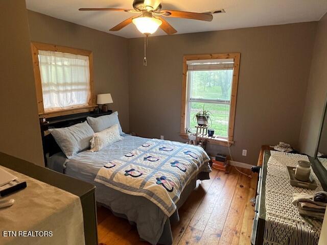 4016 Retro Hughes Rd, Graysville, TN 37338 - bedroom with light wood-style floors and ceiling fan