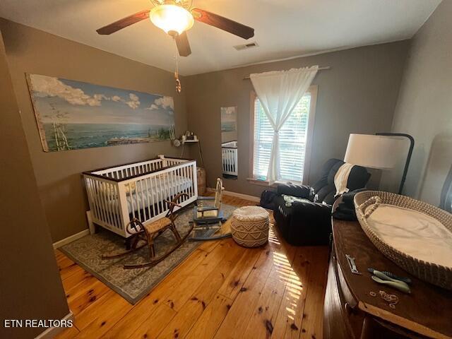 4016 Retro Hughes Rd, Graysville, TN 37338 - bedroom with hardwood / wood-style flooring and a ceiling fan
