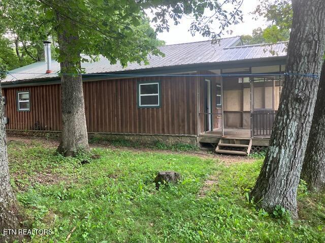 4016 Retro Hughes Rd, Graysville, TN 37338 - rear view of house featuring a metal roof and covered porch