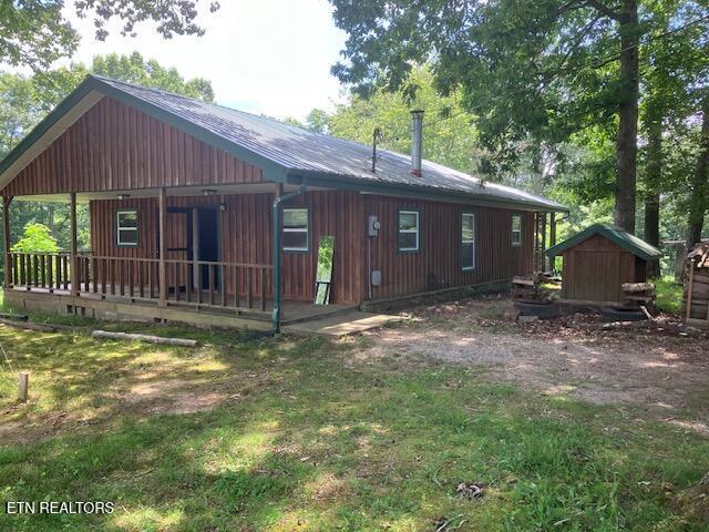 4016 Retro Hughes Rd, Graysville, TN 37338 - back of house with a shed and a metal roof