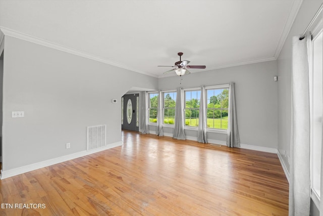 171 Wrenwood Way, Greenback, TN 37742 - unfurnished living room featuring ceiling fan, light wood-style flooring, ornamental molding, and arched walkways