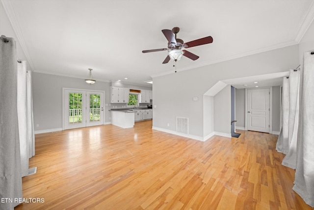 171 Wrenwood Way, Greenback, TN 37742 - unfurnished living room featuring a ceiling fan, light wood finished floors, ornamental molding, and arched walkways