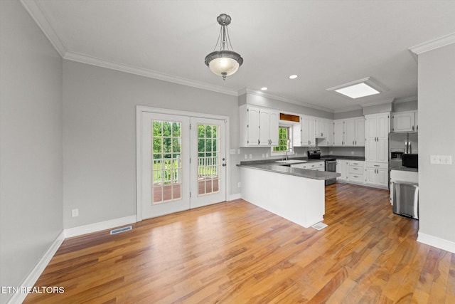 171 Wrenwood Way, Greenback, TN 37742 - kitchen featuring a peninsula, ornamental molding, light wood finished floors, white cabinetry, and stainless steel appliances