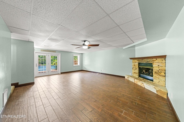 171 Wrenwood Way, Greenback, TN 37742 - unfurnished living room featuring a ceiling fan, a fireplace, wood finished floors, a paneled ceiling, and french doors