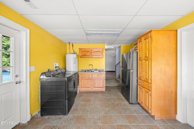 171 Wrenwood Way, Greenback, TN 37742 - kitchen with freestanding refrigerator, washing machine and clothes dryer, electric water heater, a drop ceiling, and light countertops
