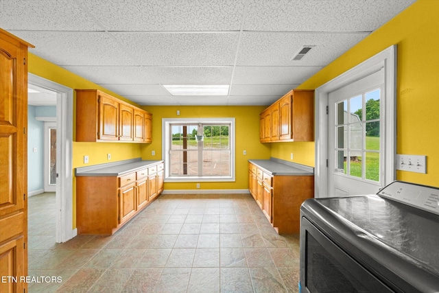 171 Wrenwood Way, Greenback, TN 37742 - kitchen with washer / dryer, a paneled ceiling, brown cabinets, and light countertops