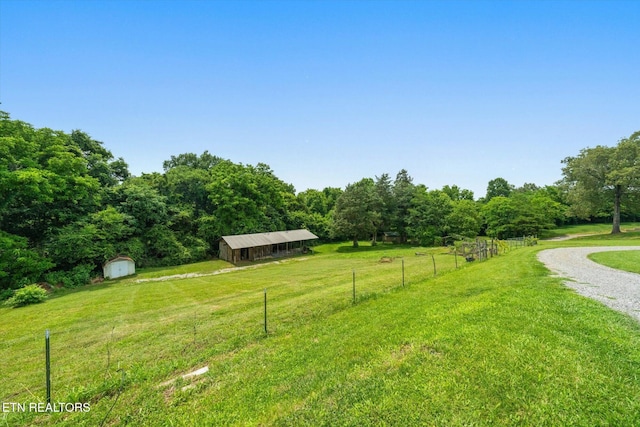 171 Wrenwood Way, Greenback, TN 37742 - view of yard featuring a storage shed, a view of countryside, driveway, and a forest view