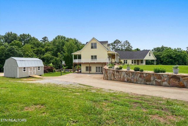 171 Wrenwood Way, Greenback, TN 37742 - back of property featuring driveway, a lawn, a storage unit, and a balcony