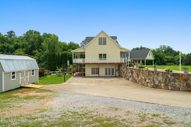 171 Wrenwood Way, Greenback, TN 37742 - back of property featuring a patio, a lawn, driveway, a shed, and a balcony