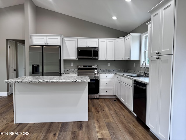408 Luttrell Rd, Maynardville, TN 37807 - kitchen featuring stainless steel appliances, lofted ceiling, white cabinets, a kitchen island, and dark wood-style floors