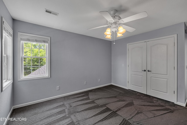 4040 Roundtop Dr, Sevierville, TN 37862 - unfurnished bedroom with dark colored carpet, a closet, and ceiling fan