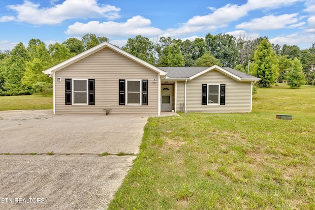 8040 Walt Way, Corryton, TN 37721 - ranch-style house featuring concrete driveway, a front lawn, and view of wooded area