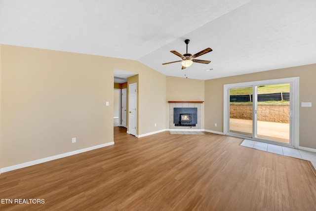 8040 Walt Way, Corryton, TN 37721 - unfurnished living room with ceiling fan, light wood-style flooring, lofted ceiling, and a fireplace