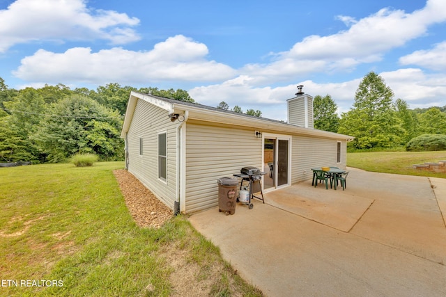 8040 Walt Way, Corryton, TN 37721 - back of property with a yard, a patio area, and a chimney