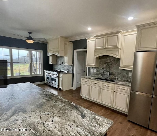 257 Holt Ridge Rd, Tazewell, TN 37879 - kitchen with stainless steel appliances, decorative backsplash, a ceiling fan, dark wood-style floors, and light stone countertops