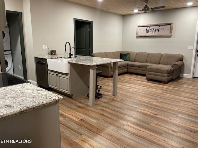 257 Holt Ridge Rd, Tazewell, TN 37879 - living room featuring stacked washer / dryer, ceiling fan, light wood-type flooring, recessed lighting, and wooden ceiling