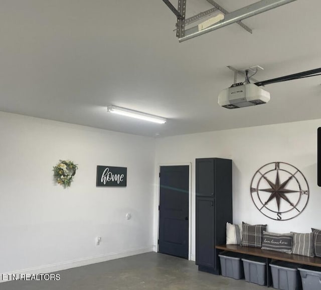 257 Holt Ridge Rd, Tazewell, TN 37879 - garage with a garage door opener and baseboards