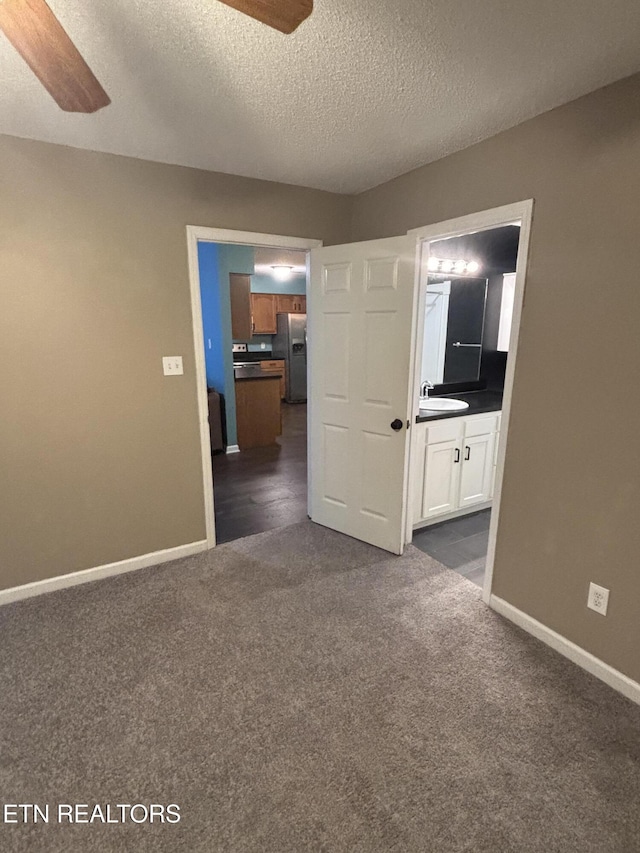 8022 Intervale Way, Powell, TN 37849 - spare room featuring ceiling fan, dark carpet, and a textured ceiling