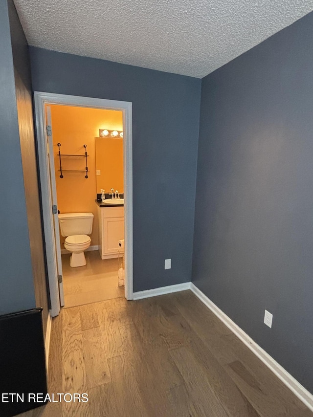 8022 Intervale Way, Powell, TN 37849 - unfurnished bedroom with wood finished floors, a textured ceiling, and ensuite bathroom