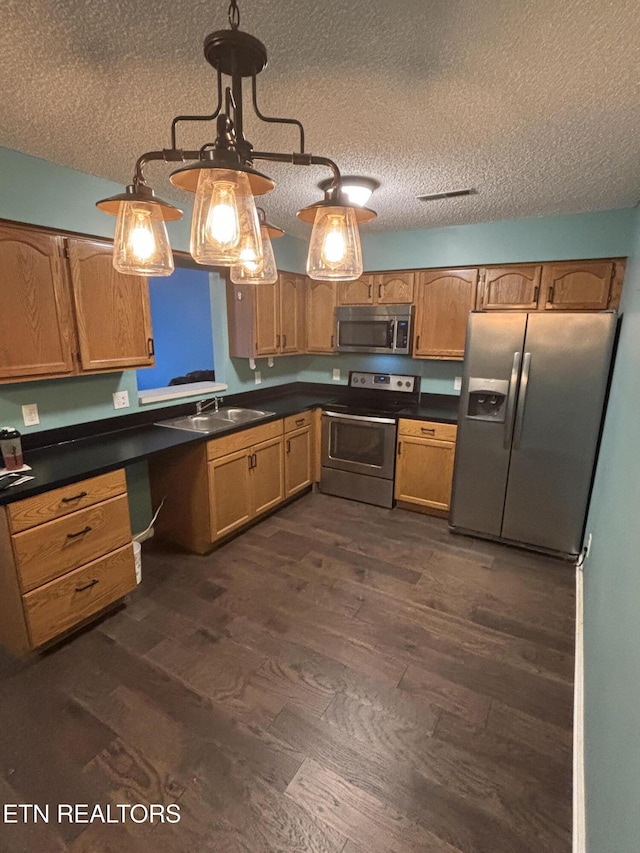 8022 Intervale Way, Powell, TN 37849 - kitchen with stainless steel appliances, a textured ceiling, dark wood-type flooring, and dark countertops