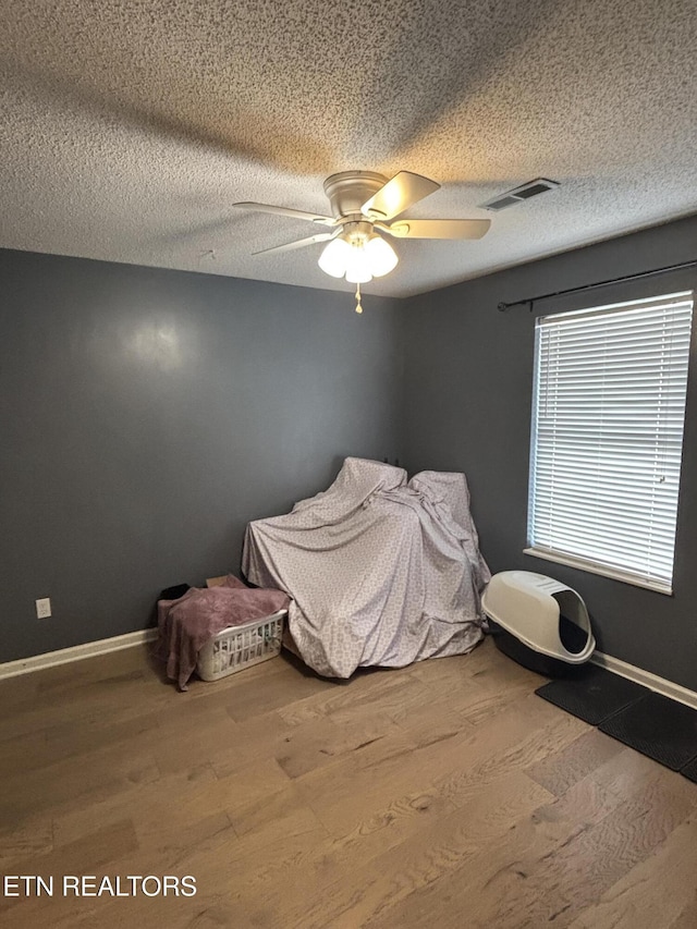 8022 Intervale Way, Powell, TN 37849 - unfurnished bedroom featuring wood finished floors, ceiling fan, and a textured ceiling